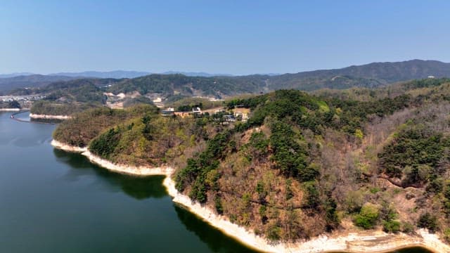 Scenic view of a forested mountain and lake