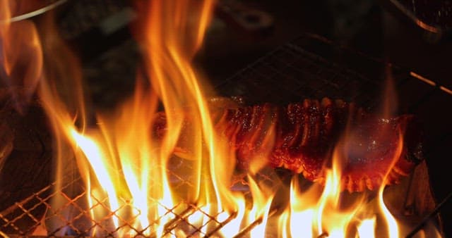 Sizzling squid being cooked on a grill