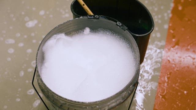 Wetting a Scrubber with Soapy Water for Cleaning