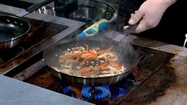 Stir-frying vegetables in a pan