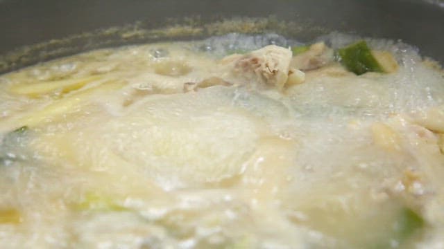 Kimchi added to boiling chicken hotpot