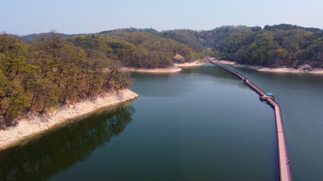 Serene lake with a long wooden bridge