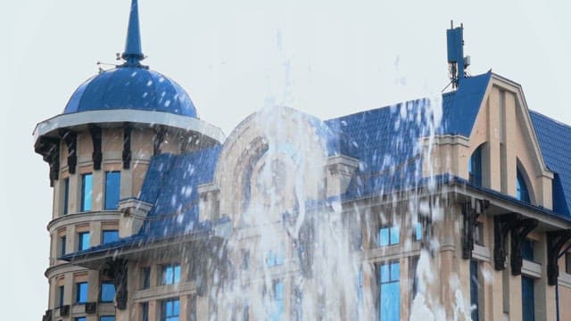 Fountain in front of a blue-roofed building