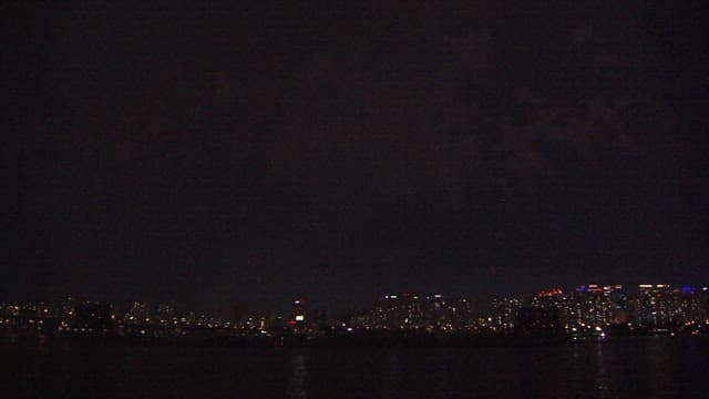 Colorful Fireworks Display Over the City Skyline and River
