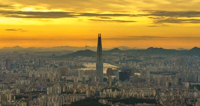 Panoramic view of the bustling city skyline and red sunset