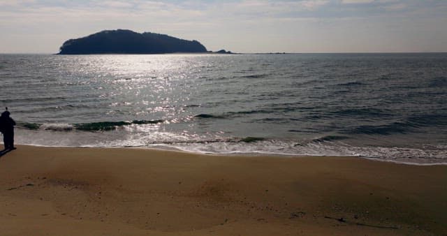 Beach with Distant Hills Beyond the Sea