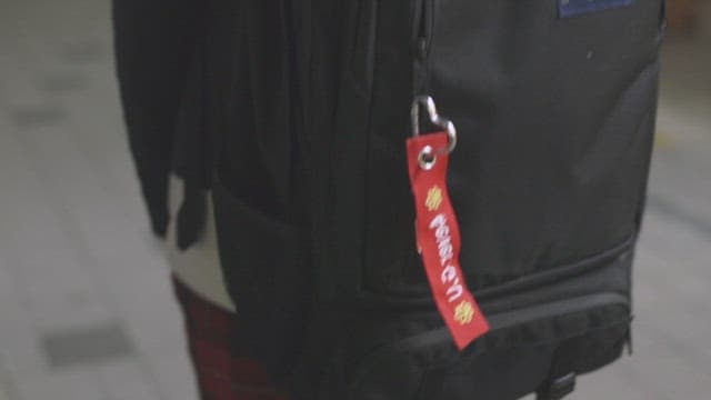 Black backpack with a red tag