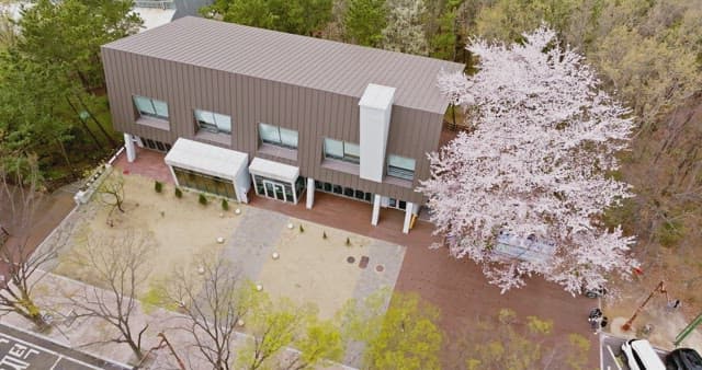 Modern building surrounded by cherry blossoms