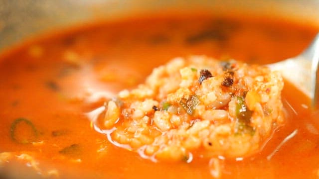 Spoonful of rice ball in ramen broth