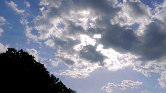 Clouds moving across a bright sky
