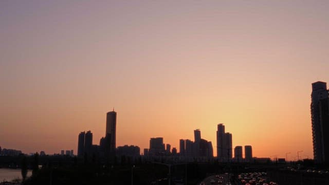 City Skyline Silhouetted by Sunset Glow