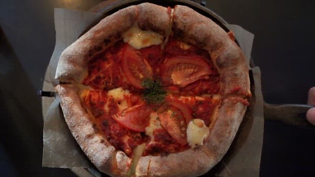 Pizza with fresh tomatoes and cheese in a restaurant