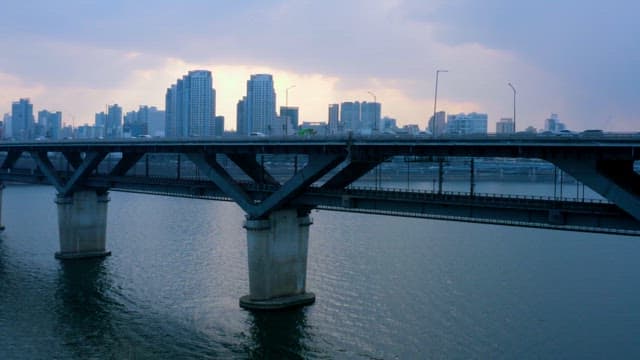 Cityscape with Bridge Over River at Dusk