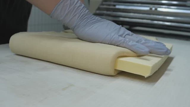 Person preparing bread dough and butter in a bakery