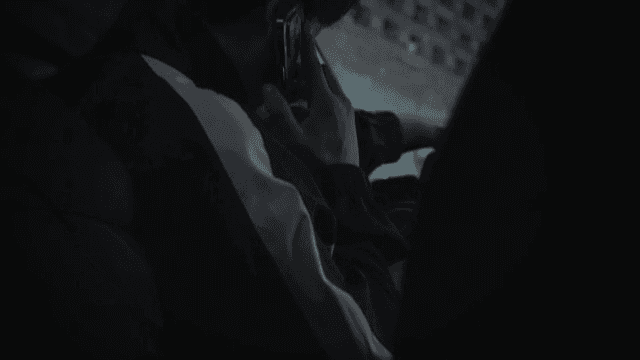 Person Using Cellphone in Vehicle at Night