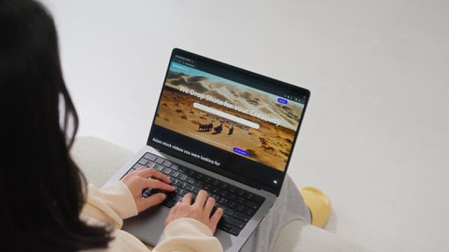 Woman browsing the internet on a laptop