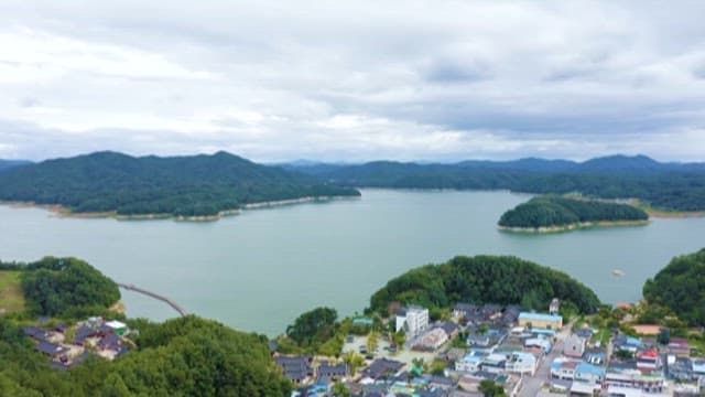 Aerial View of Lakeside Town Surrounded by Mountains