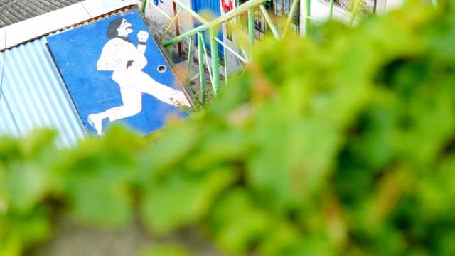 Ivy with a running man mural in the background