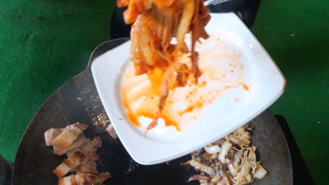 Pork belly and kimchi grilled on a grill