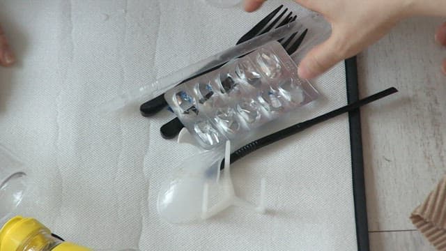 Various plastic waste listed on the floor