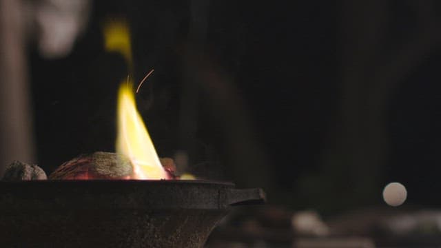 A flame flickering on a calm evening