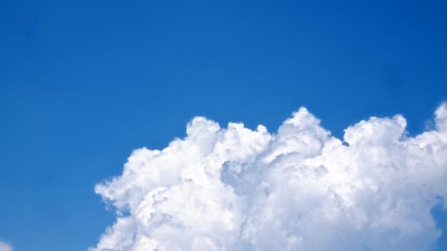 Clear blue sky with white fluffy cloudsin the afternoon