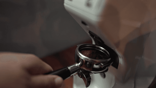 Coffee grinder preparing fresh grounds