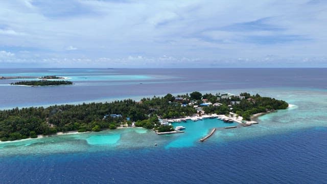 Tropical island in Maldives with clear blue sea