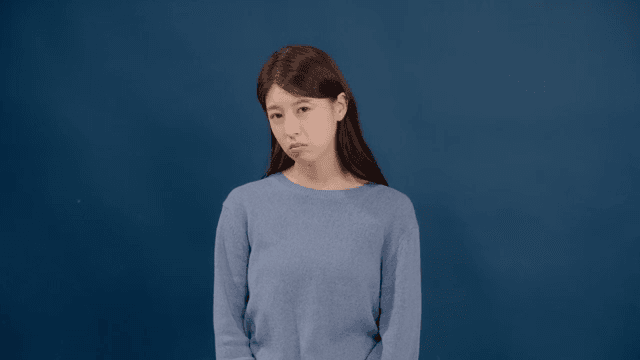 Long haired woman with a disappointed and desperate expression expressing dissatisfaction