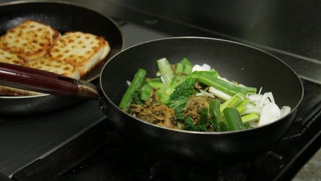 Braised tofu and fermented kimchi cooked in a frying pan