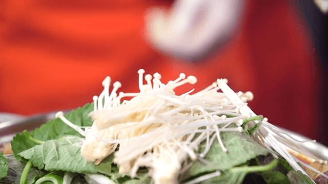 Perilla leaf and enoki mushroom being prepared
