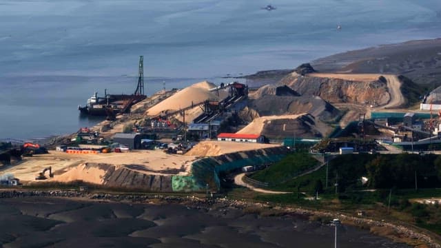 Coastal industrial site with machinery