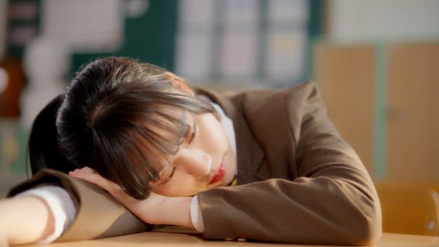 Student resting in a classroom