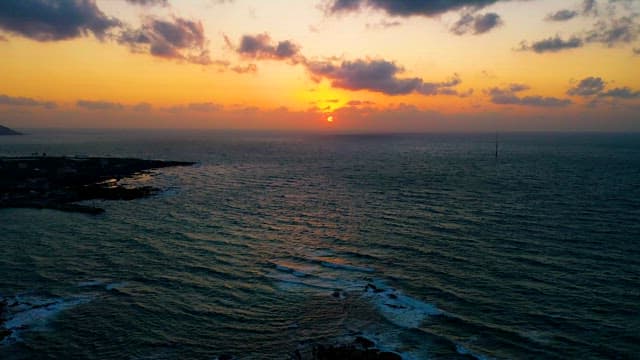 Sunset Beyond the Horizon of a Calmly Flowing Sea