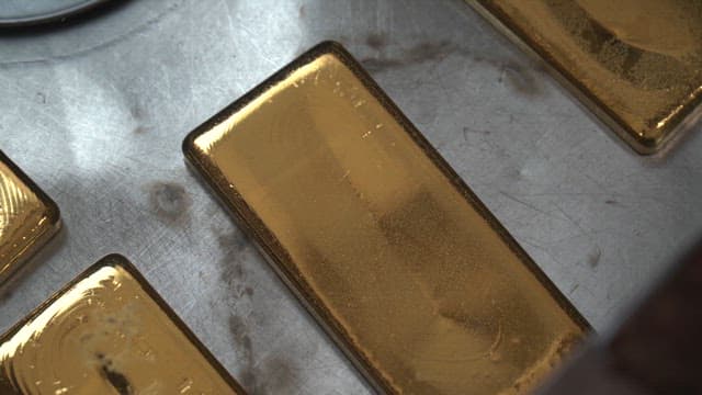 Gold bars on a metal surface