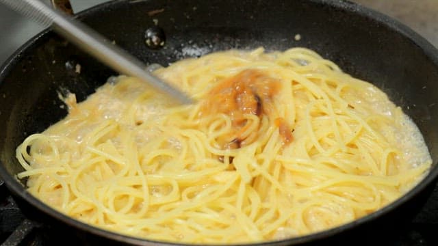 Pasta being stirred in a pan