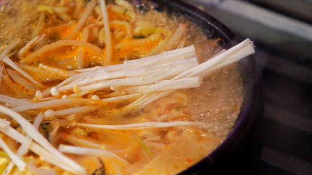 Ramyeon boiling with enoki mushrooms