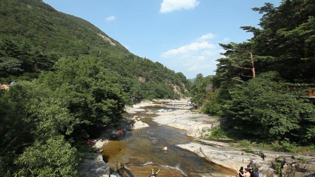 People Enjoying Sunny Day at a Mountain Valley