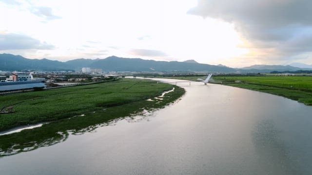 River flowing through a cityscape with mountains