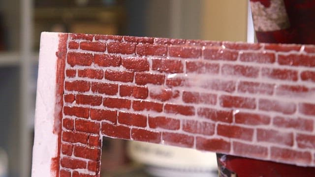 Elaborate cardboard painted with a brick pattern frame