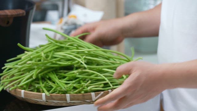 Fresh sweet potato stem prepared in the kitchen are placed in a pot