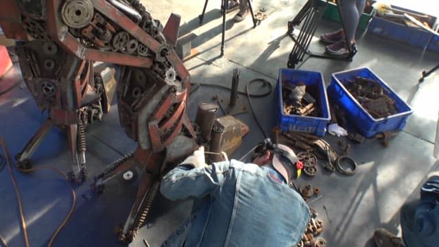 Engineers welding and repairing large machines