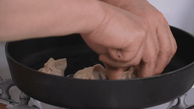 Cooking dumplings in a heated frying pan