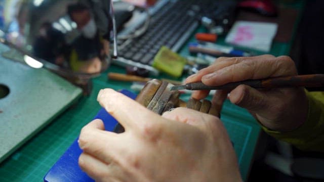 Artisan Carving Intricate Designs in Workshop