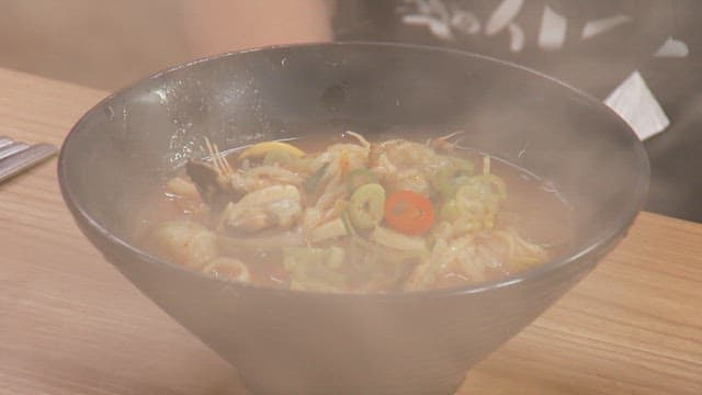 Bowl of hot spicy stew on a wooden table