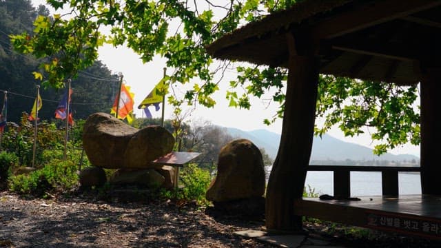 Rock tower surrounded by trees and greenery