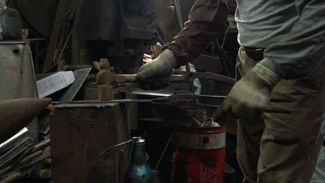 Craftsman forging a heated metal blade