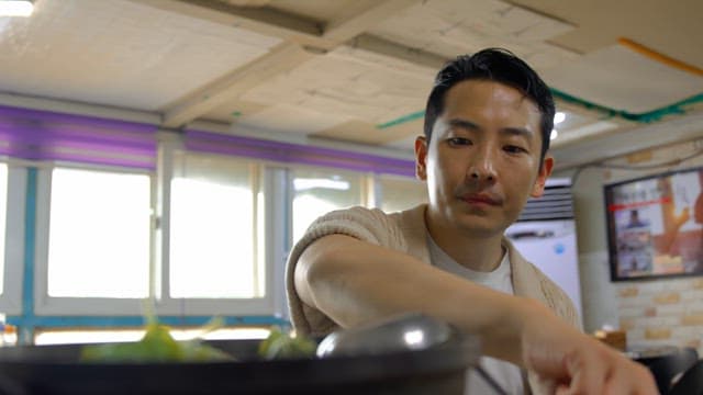 Man stirring soup in a restaurant