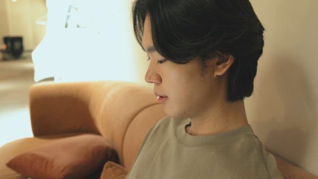 Young man sitting on a sofa indoors