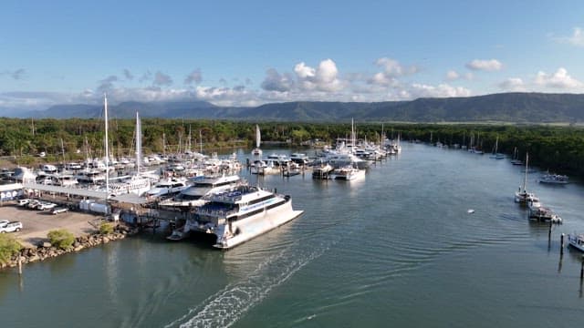 Marina with yachts and boats docked on the sunny day